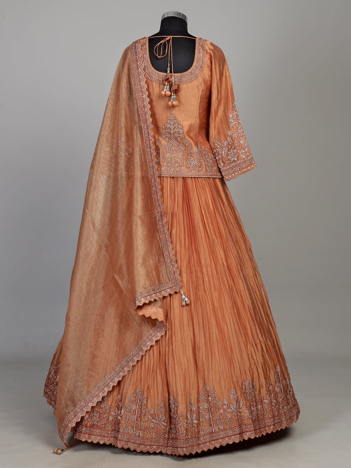 Pastel peach tissue silk lehenga choli with embellished sweetheart neckline