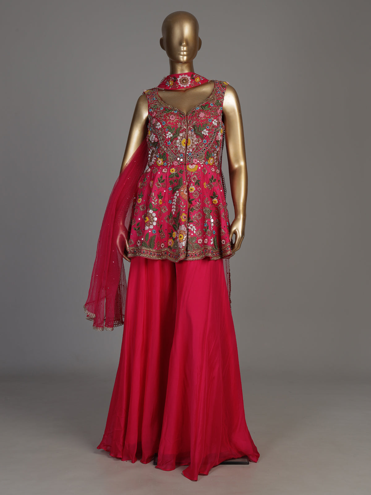 Rani pink silk palazzo suit with mirror work and net dupatta