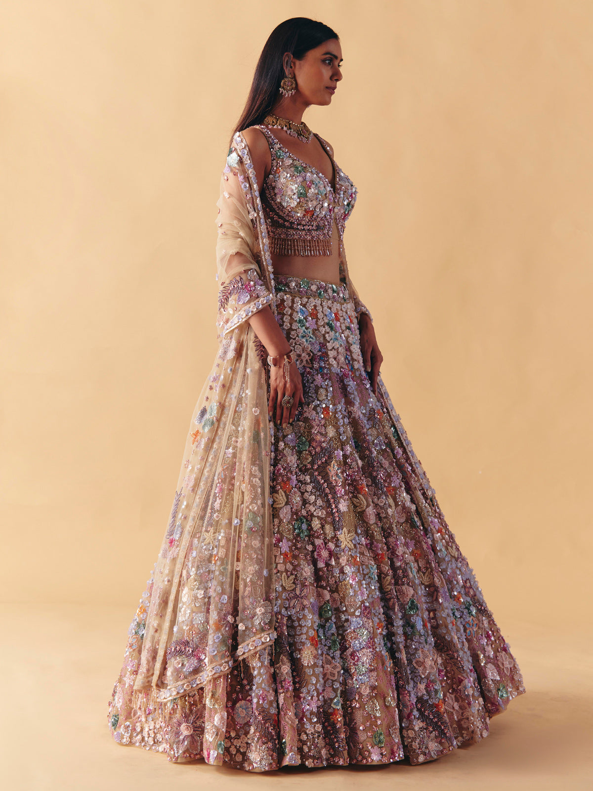 Beige net lehenga choli with beaded and pearl accents