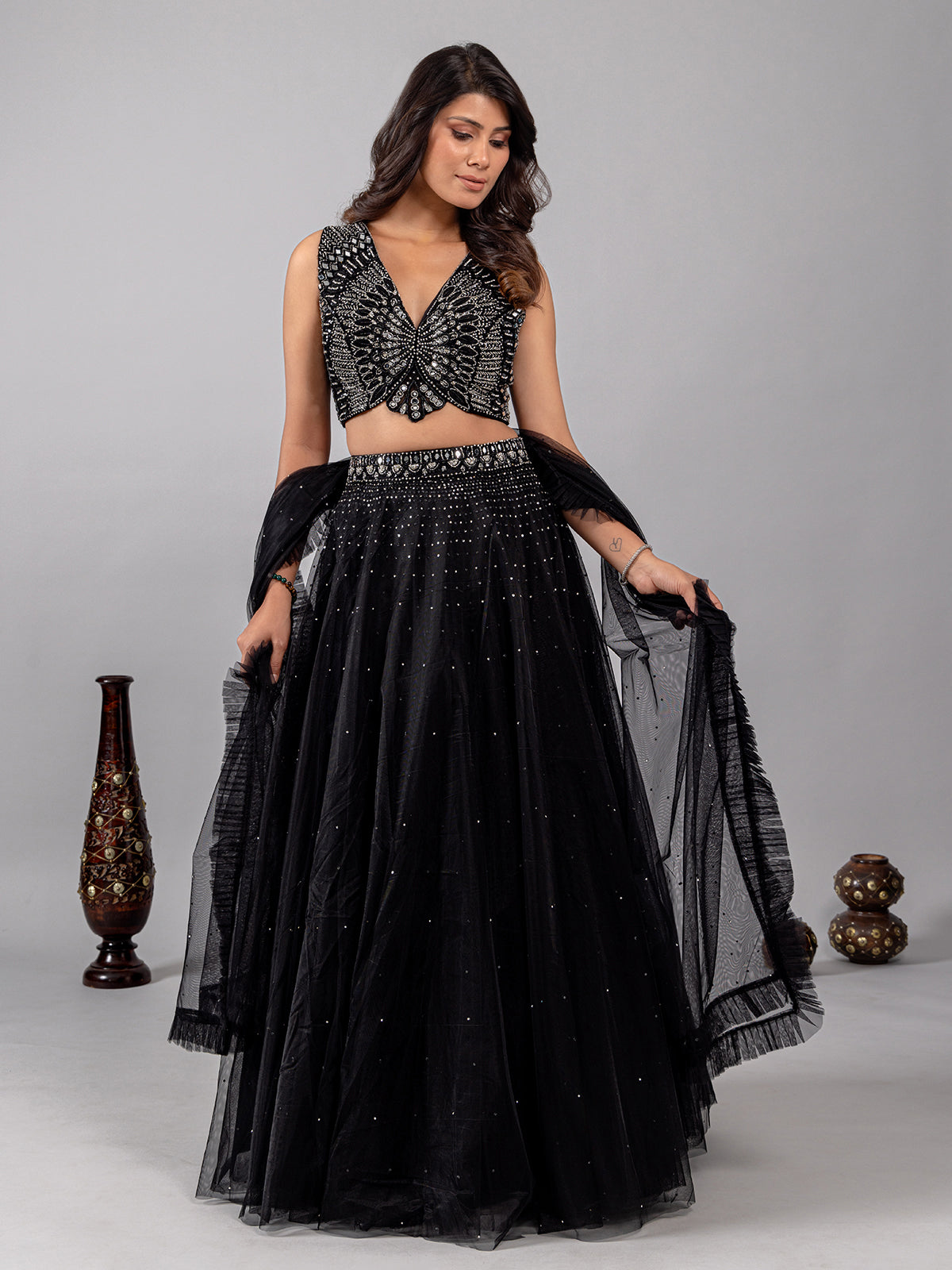 Black net lehenga choli with shimmering mirror accents