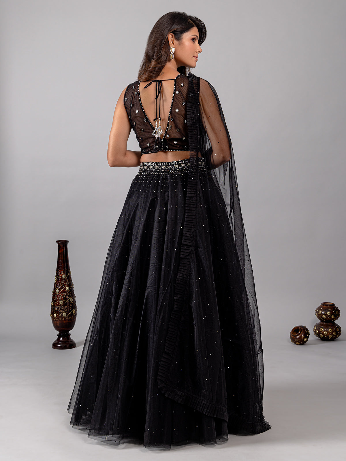 Black net lehenga choli with shimmering mirror accents