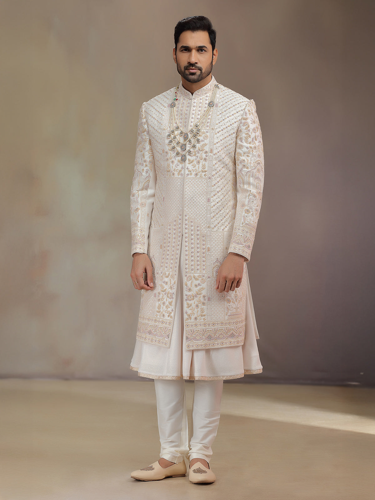Cream peshwa style silk sherwani with rich embroidery