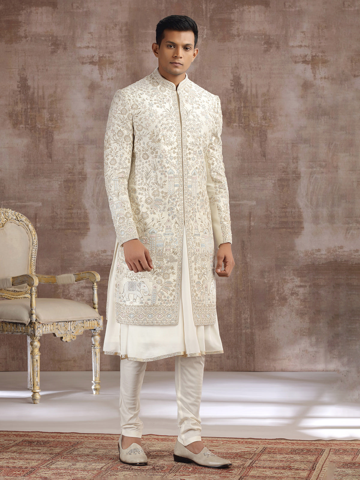 Cream silk peshwai sherwani with heavy embellishments