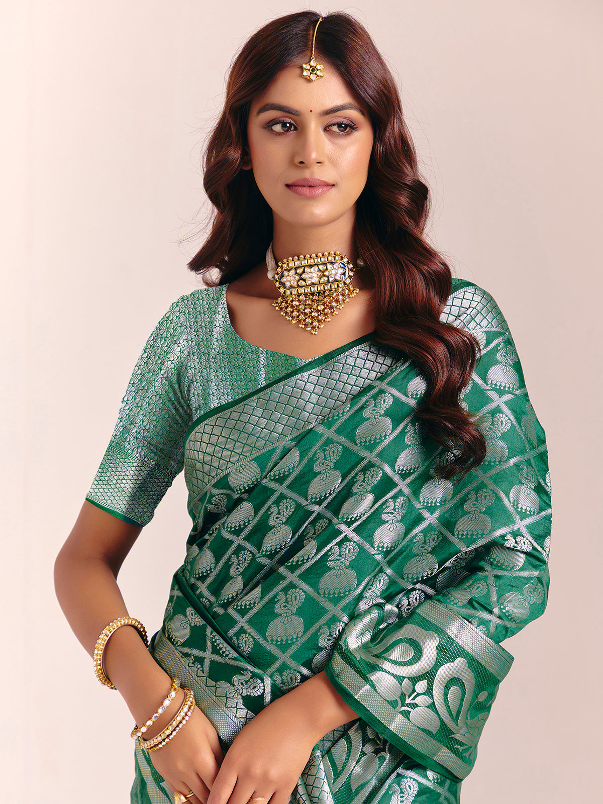 Green silk saree featuring traditional zari detailing