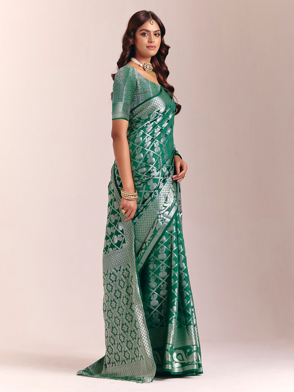 Green silk saree featuring traditional zari detailing