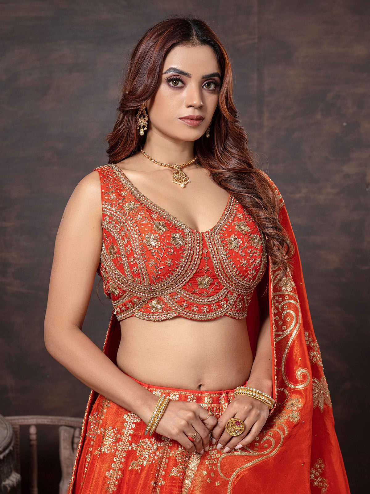 Orange sleeveless lehenga choli with dupatta