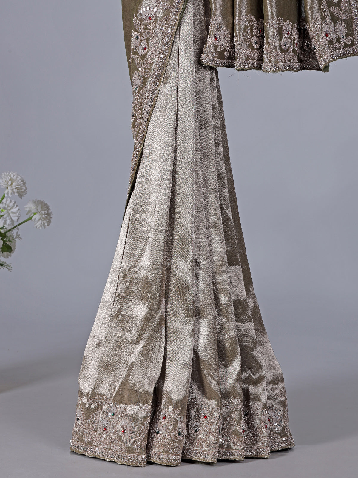 Pastel olive soft tissue silk saree with intricate festive embellishments