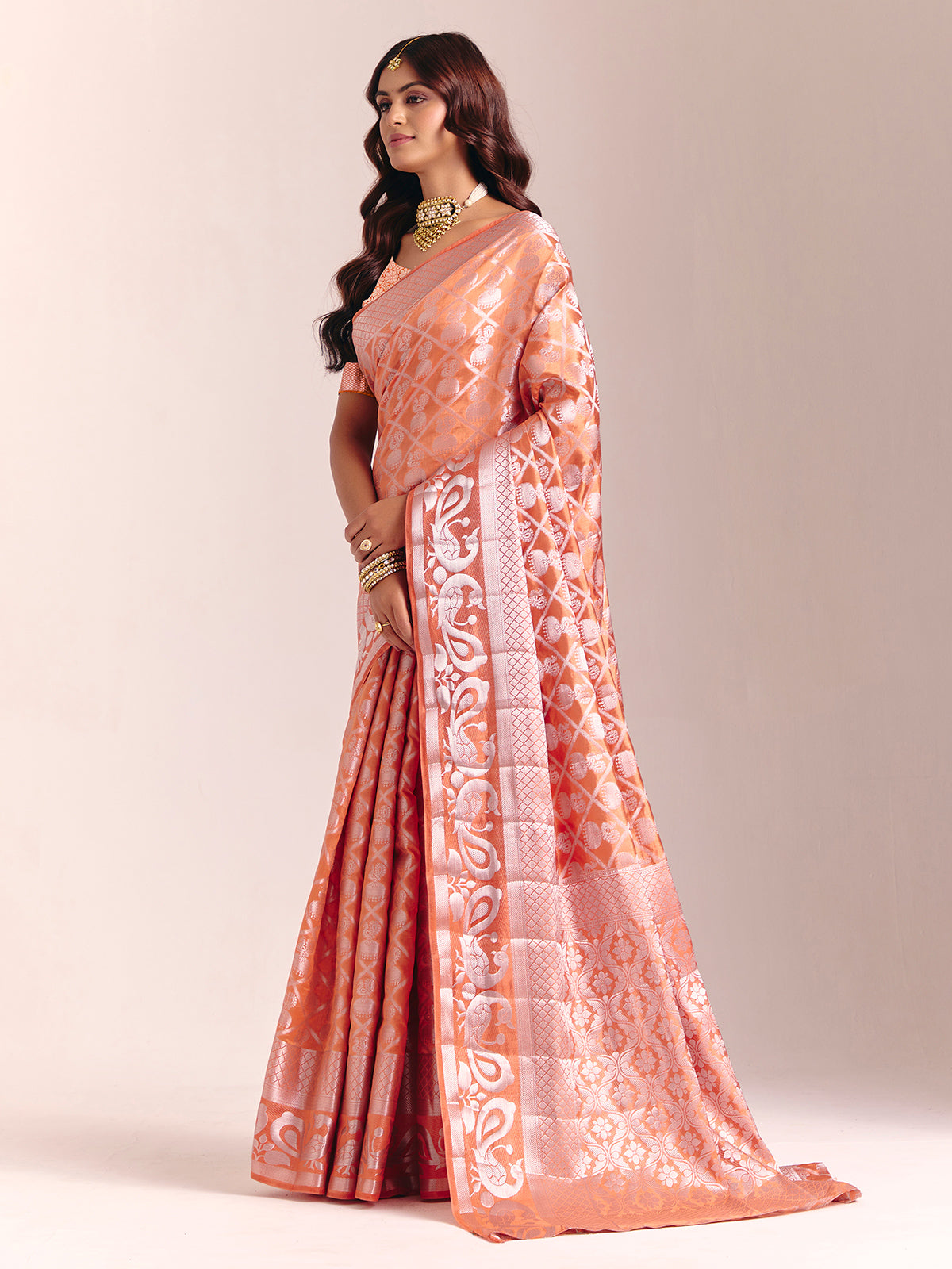 Peach silk saree accented with classic zari work