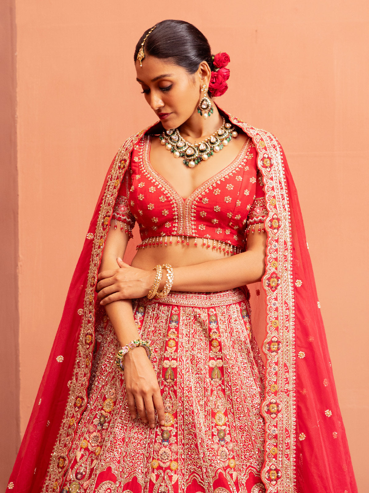 Red bridal lehenga choli with embellished blouse