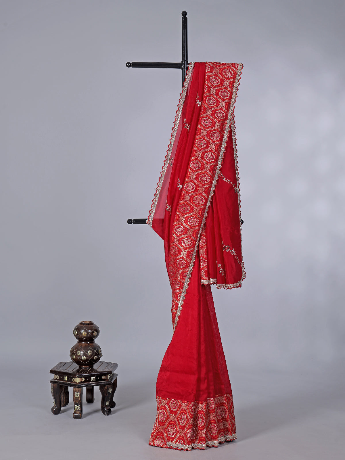 Red dola silk saree with sparkling festive embellishments
