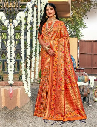 Beautiful orange colored patola silk saree for wedding look
