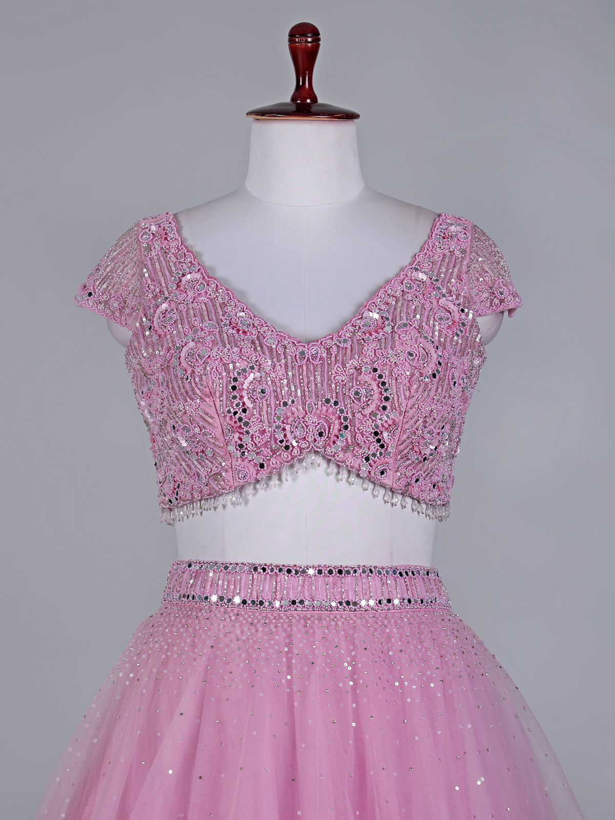 Light pink net lehenga choli with mirror and stone work