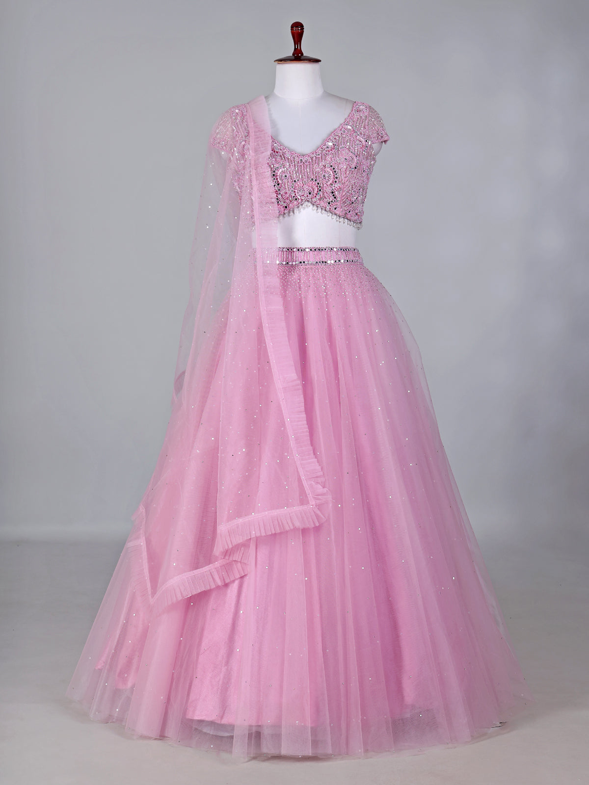 Light pink net lehenga choli with mirror and stone work