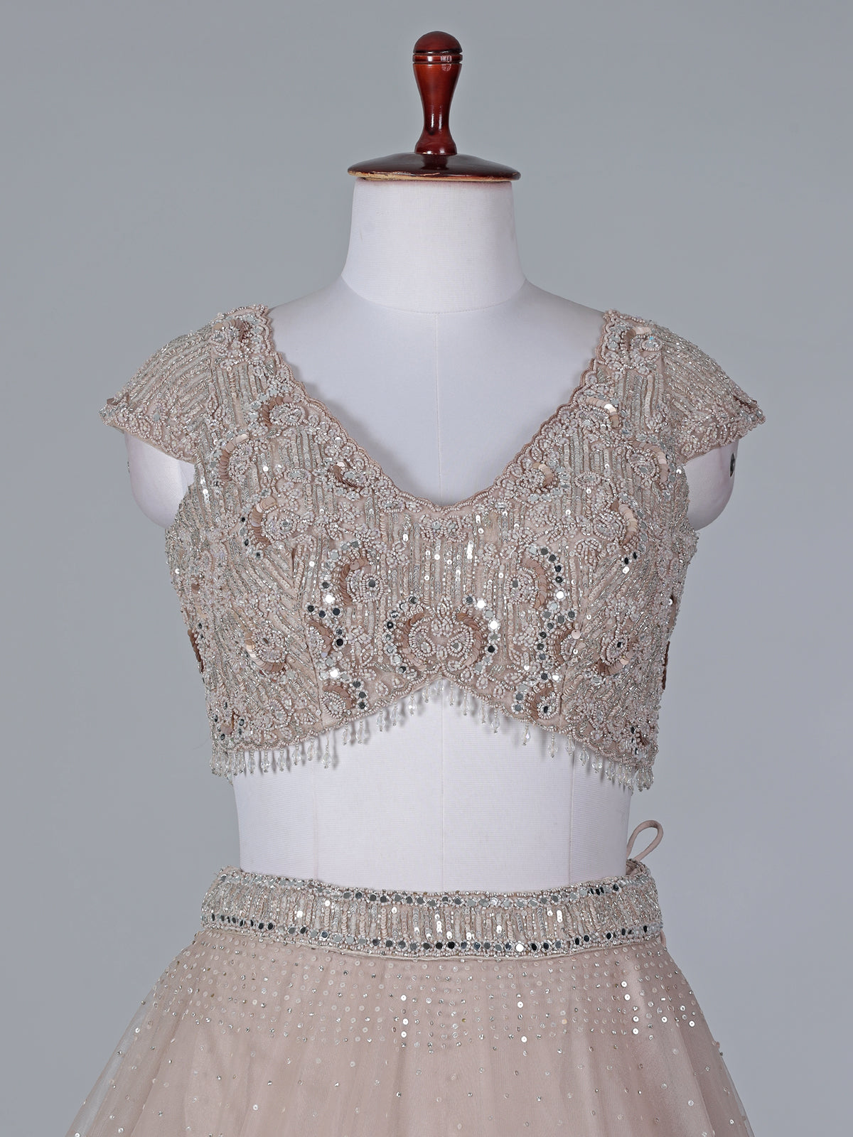 Beige net mirror embellished lehenga choli with dupatta