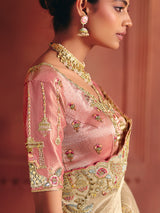 Beige bridal saree featuring exquisite traditional craftsmanship