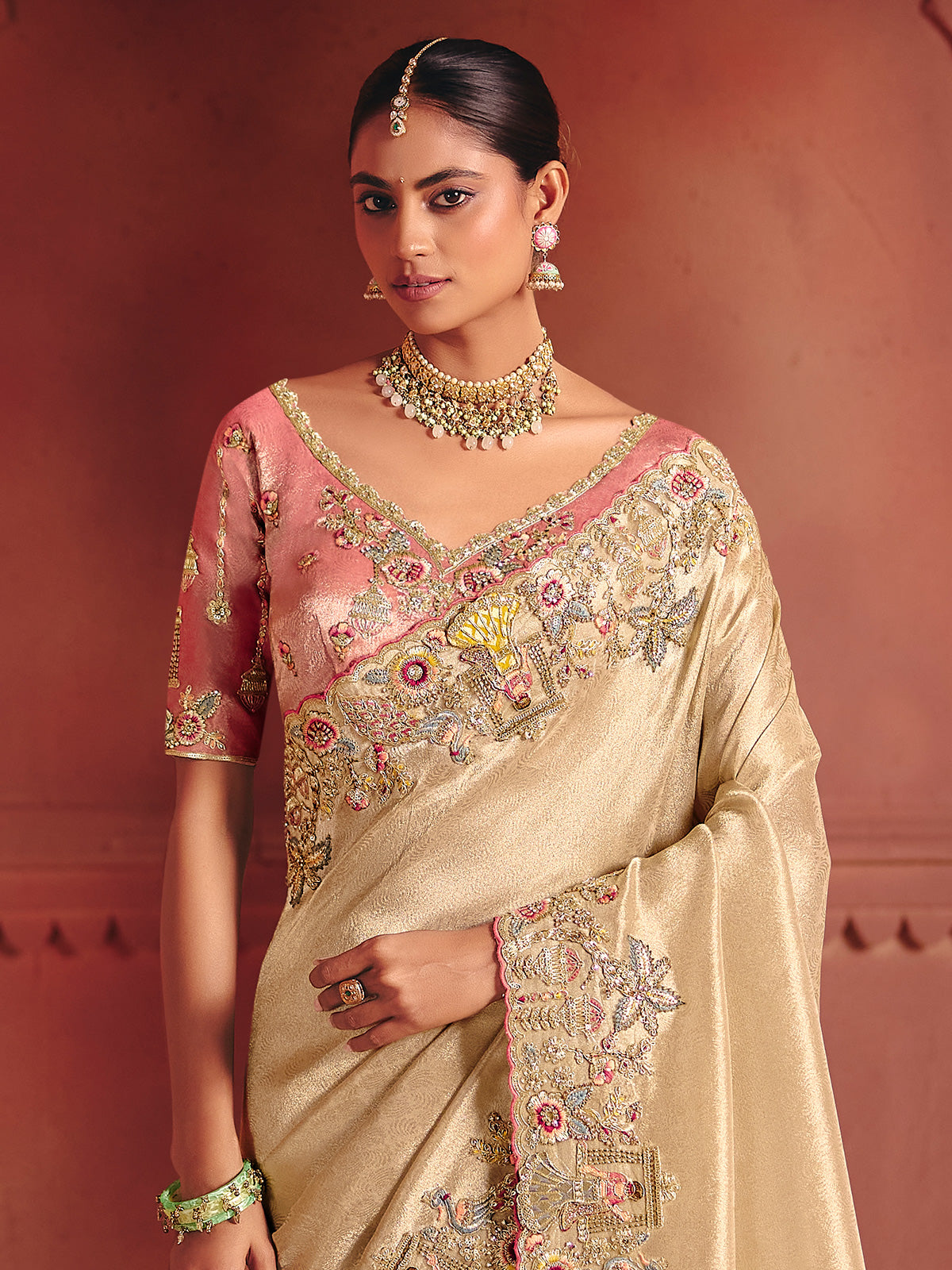 Beige bridal saree featuring exquisite traditional craftsmanship