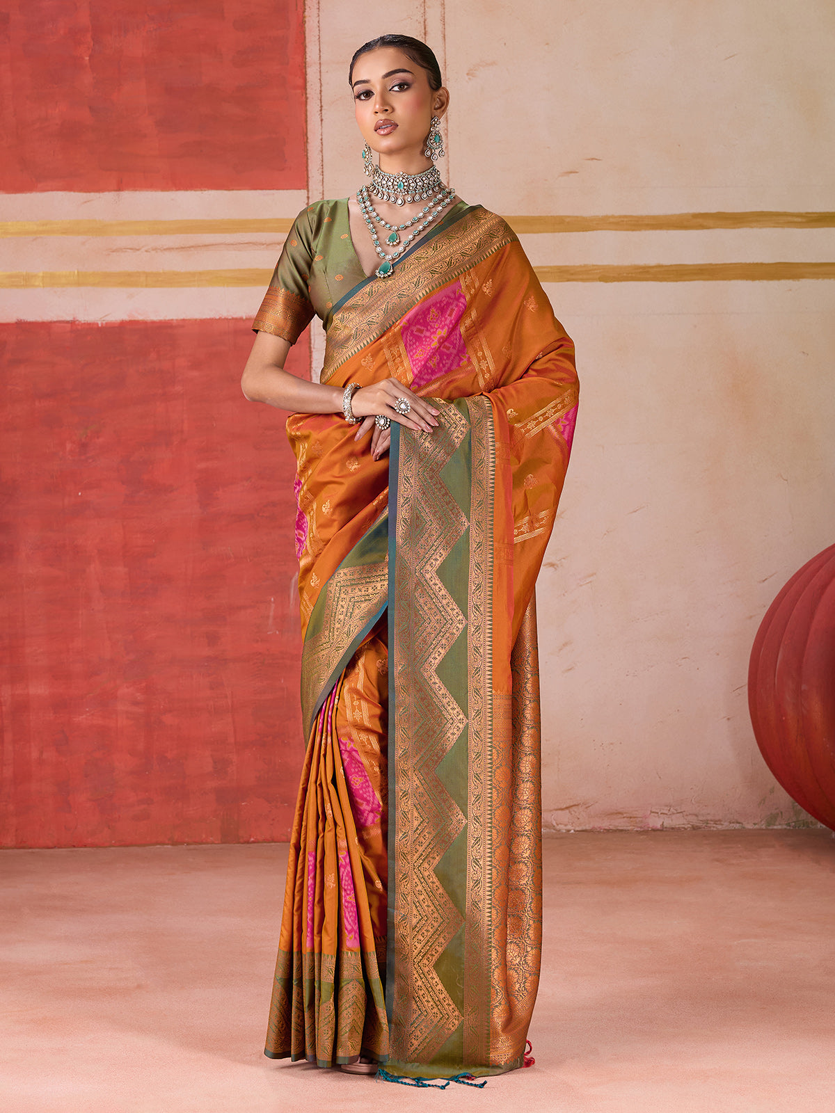 Orange silk saree with bold green border