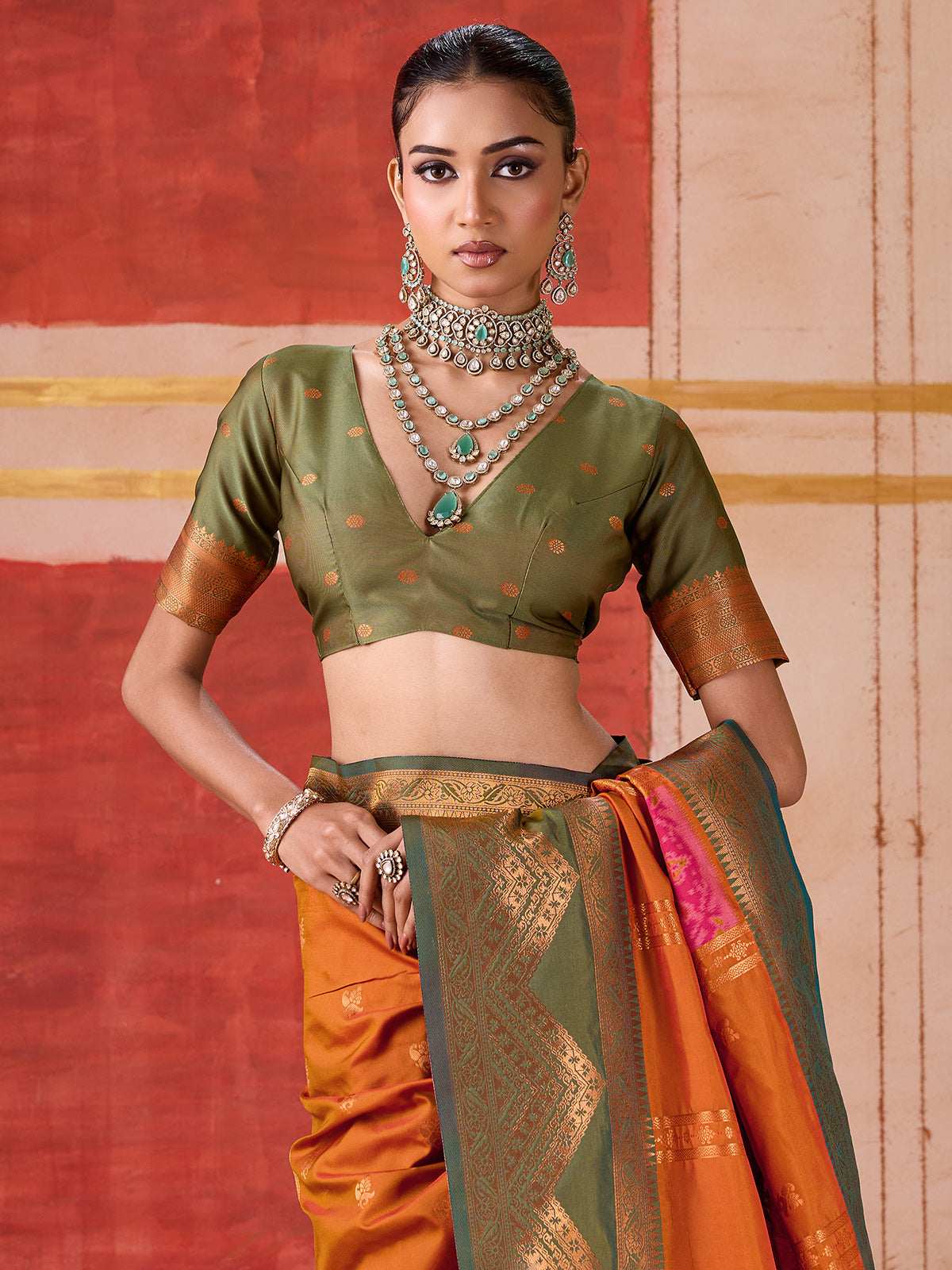 Orange silk saree with bold green border