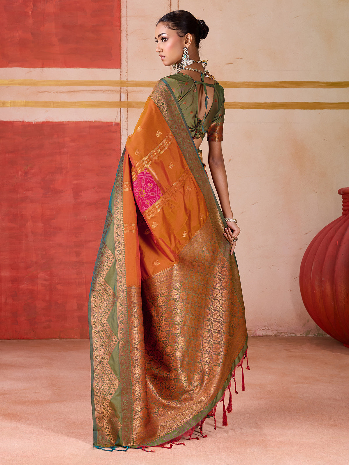 Orange silk saree with bold green border