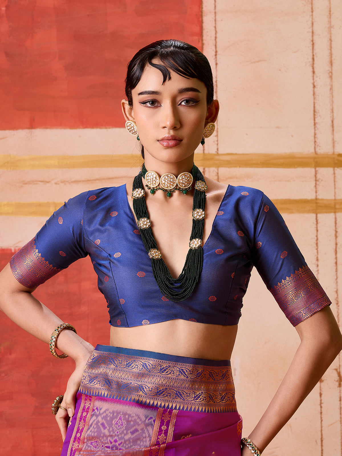 Violet silk saree with bold green and blue accents