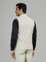 Light beige linen waistcoat for reception wear with crest detailing