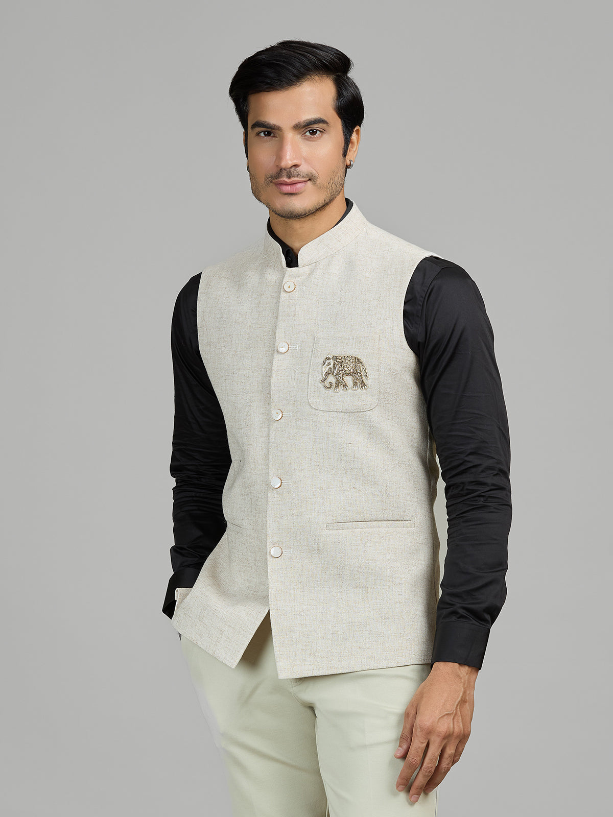 Light beige linen waistcoat for reception wear with crest detailing