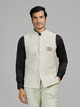 Light beige linen waistcoat for reception wear with crest detailing