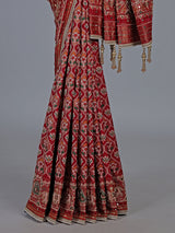 Crimson maroon art patola silk saree with embellished detailing