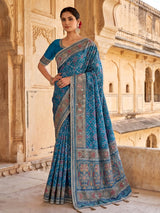 Bright blue art patola silk saree with shimmering embellishments