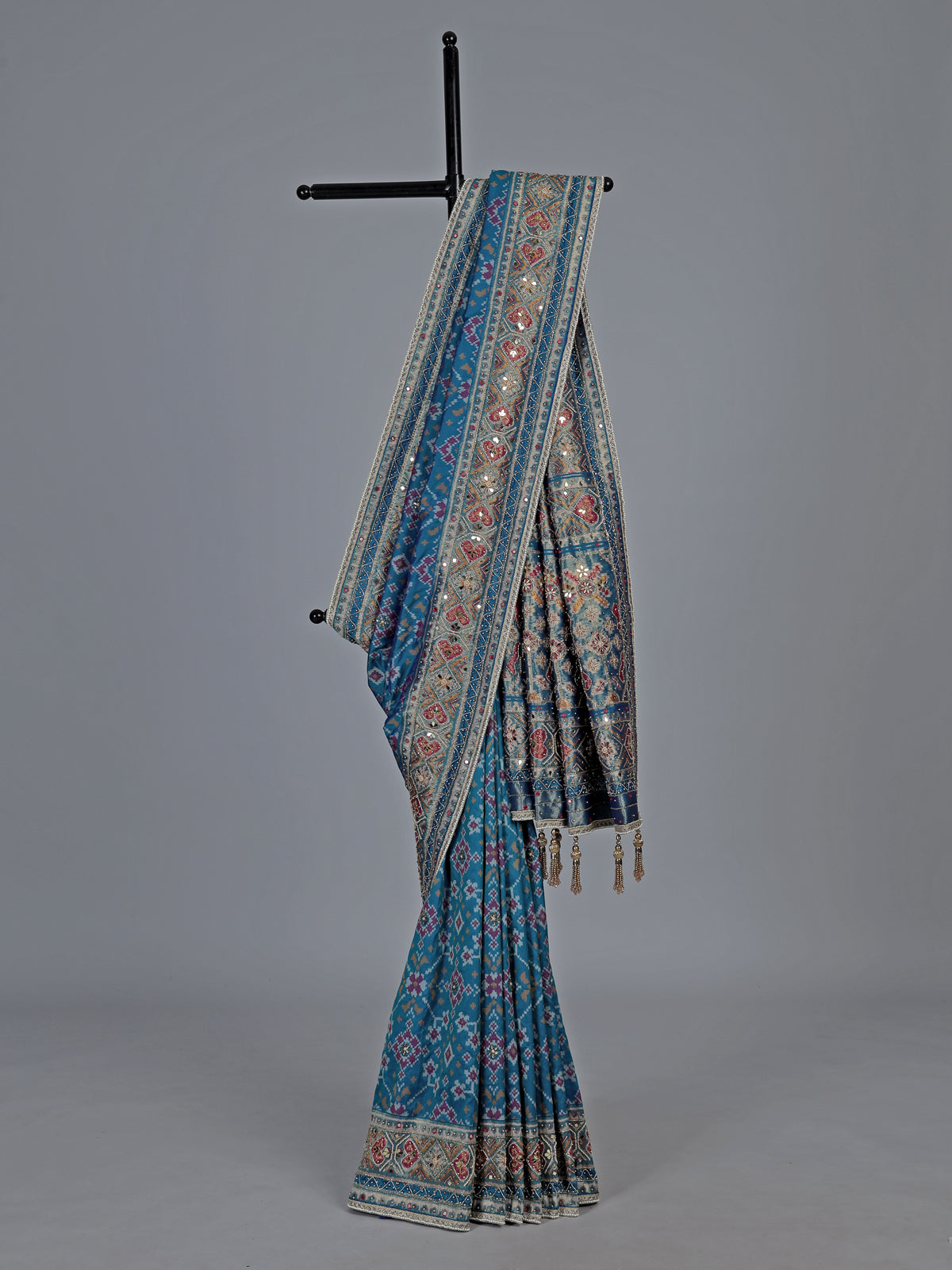 Bright blue art patola silk saree with shimmering embellishments