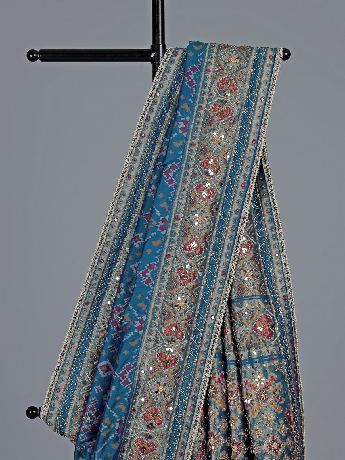 Bright blue art patola silk saree with shimmering embellishments