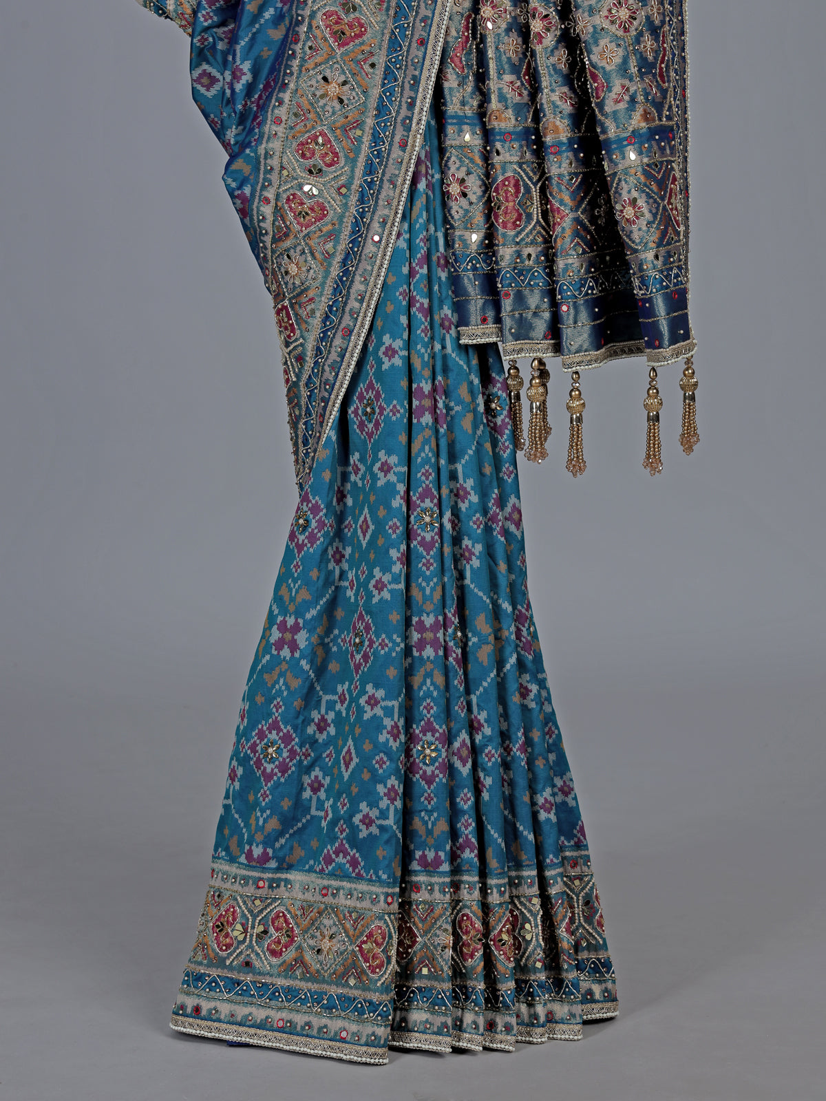 Bright blue art patola silk saree with shimmering embellishments