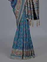Bright blue art patola silk saree with shimmering embellishments