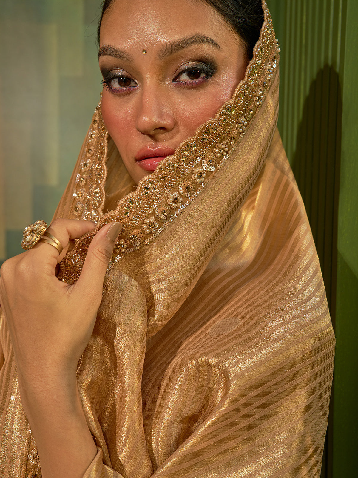 Golden silk lehenga choli with woven motifs and tissue dupatta