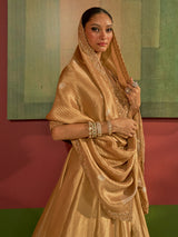 Golden silk lehenga choli with woven motifs and tissue dupatta