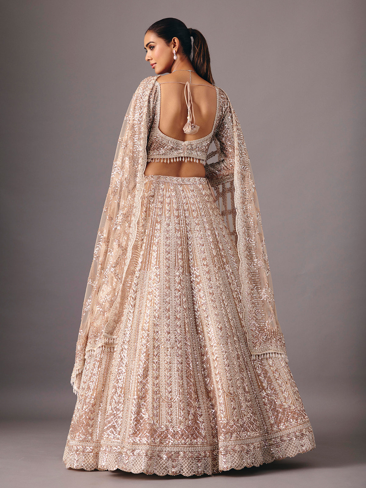 Beige net lehenga choli with pearl and sequin detailing