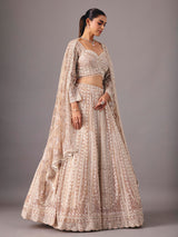 Beige net lehenga choli with pearl and sequin detailing