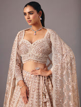 Beige net lehenga choli with pearl and sequin detailing
