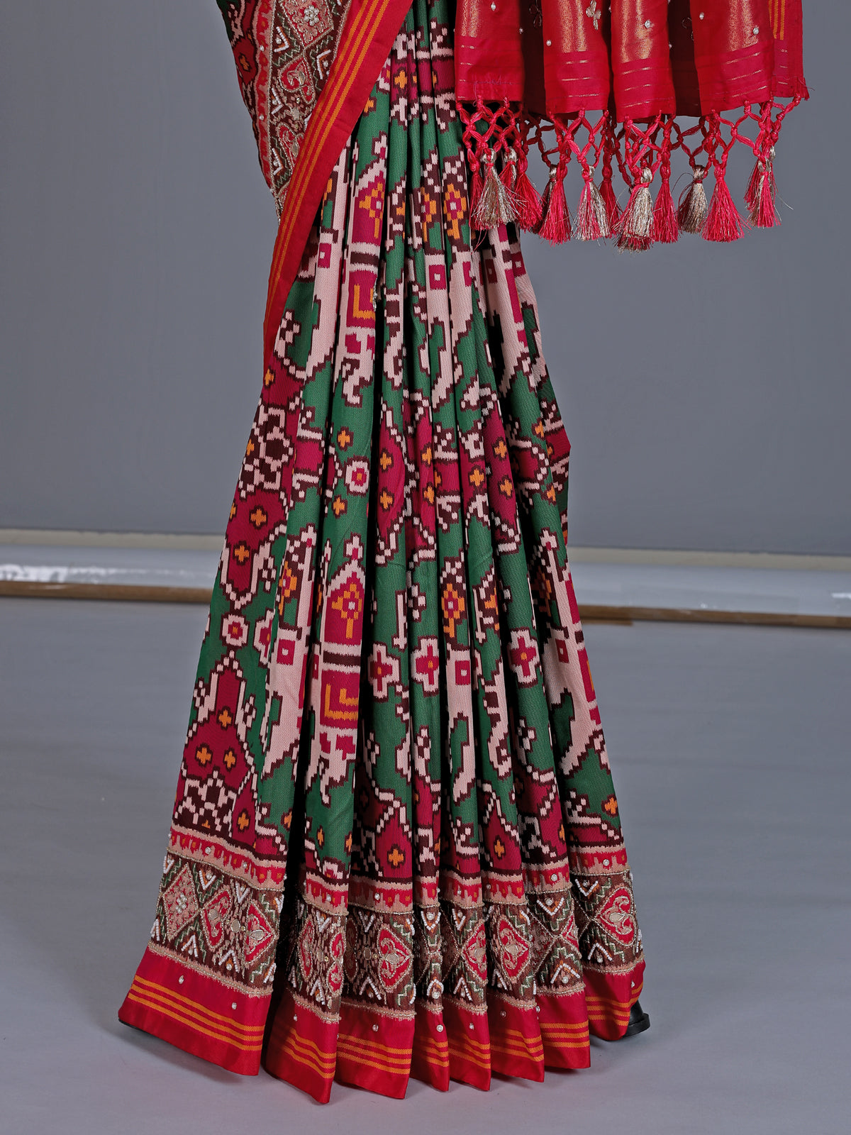 Green art patola silk saree with elephant motif detailing