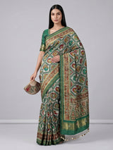 Green and white patola silk saree with rich embellishments