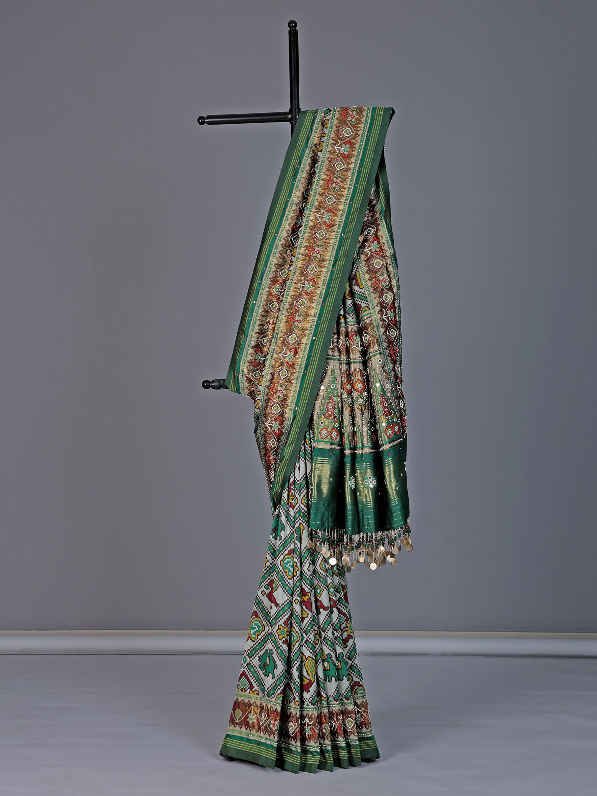 Green and white patola silk saree with rich embellishments