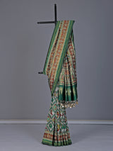 Green and white patola silk saree with rich embellishments