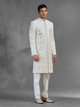 Cream silk sherwani with aqua peacock thread work design