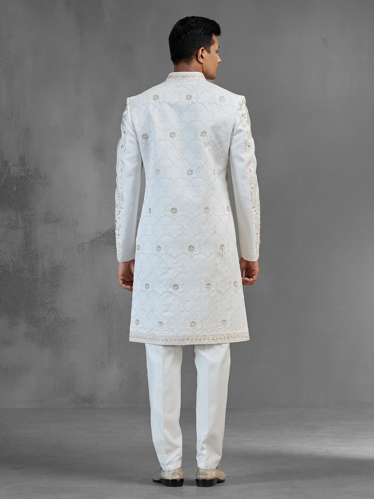 Cream silk sherwani with aqua peacock thread work design