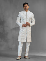 Cream silk sherwani with aqua peacock thread work design