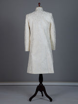 White raw silk sherwani with intricate embroidery and stone detailing