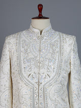 White raw silk sherwani with intricate embroidery and stone detailing