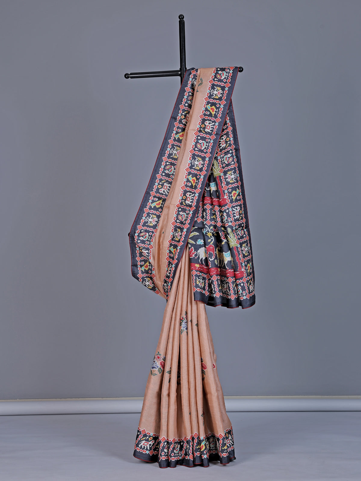 Soft peach art tusser silk saree with artistic prints and rich pallu