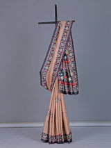 Soft peach art tusser silk saree with artistic prints and rich pallu