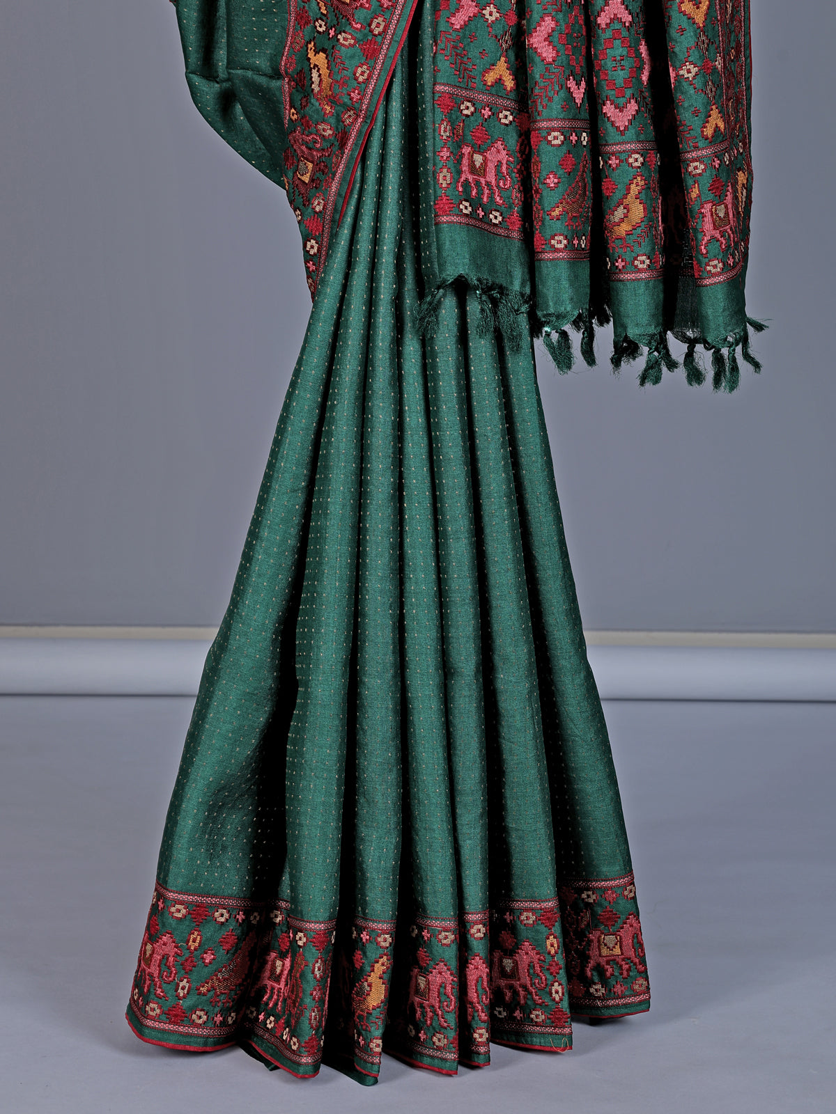 Deep green tusser silk saree with intricate animal motif artistry